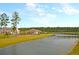 Picturesque community lake and clubhouse enhance the outdoor living at this home at 572 Tidewater Chase Ln, Summerville, SC 29486