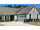 Charming single-story home boasts a well-manicured lawn, light gray siding and attached garage at 572 Tidewater Chase Ln, Summerville, SC 29486