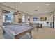 Spacious game room featuring pool table, high-top tables, and wall-mounted TVs for entertainment at 572 Tidewater Chase Ln, Summerville, SC 29486