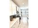 Modern kitchen features white cabinetry, stainless steel appliances, and an open layout at 572 Tidewater Chase Ln, Summerville, SC 29486