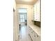 Bright kitchen features white cabinetry, stainless steel appliances, and long countertop at 572 Tidewater Chase Ln, Summerville, SC 29486