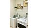 Laundry room featuring modern washer and dryer units with framed art and shelving at 572 Tidewater Chase Ln, Summerville, SC 29486