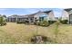 Home backyard featuring covered patio, outdoor grill, manicured shrubs, and well maintained lawn at 614 Battery Edge Dr, Summerville, SC 29486