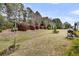 Well-maintained backyard with mature trees, shrubs, and outdoor grill at 614 Battery Edge Dr, Summerville, SC 29486