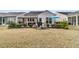 Home backyard featuring a covered patio, outdoor seating, barbeque grill, and landscaped lawn at 614 Battery Edge Dr, Summerville, SC 29486