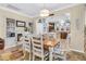 Charming dining area with an adjacent fireplace, a view to the kitchen, and a floral area rug at 614 Battery Edge Dr, Summerville, SC 29486