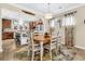 Inviting dining area with an open view of the kitchen, hardwood floors, and a farmhouse-style table at 614 Battery Edge Dr, Summerville, SC 29486