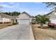 Home's exterior features a spacious driveway, attached garage, and beautiful landscaping at 614 Battery Edge Dr, Summerville, SC 29486