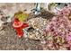 Detailed shot of a charming garden featuring a red water pump, rocks, and various plants and flowers at 614 Battery Edge Dr, Summerville, SC 29486
