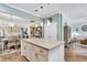 Spacious island featuring granite countertops and ample storage space, open to dining and living areas at 614 Battery Edge Dr, Summerville, SC 29486