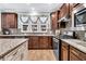 Well-lit kitchen featuring dark wood cabinets, stainless steel appliances, and a decorative tile backsplash at 614 Battery Edge Dr, Summerville, SC 29486