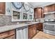 Kitchen featuring granite countertops, stainless steel appliances, and views of the backyard through large windows at 614 Battery Edge Dr, Summerville, SC 29486