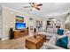 Spacious living room features hardwood floors, a large sectional, entertainment center, and an open floor plan at 614 Battery Edge Dr, Summerville, SC 29486