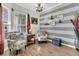 Bright living room with wood floors, two armchairs, striped accent wall and large window at 614 Battery Edge Dr, Summerville, SC 29486