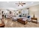 Open-concept living room with modern sectional, wood floors, and an adjacent dining and kitchen area at 614 Battery Edge Dr, Summerville, SC 29486