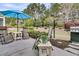 Relaxing outdoor patio setting with comfortable lounge chairs, table, umbrella, and lush landscaping at 614 Battery Edge Dr, Summerville, SC 29486