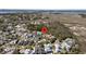 An aerial view showcases a well-planned neighborhood with winding roads and lush landscaping near the waterfront at 740 Stucco Ln, Mount Pleasant, SC 29464