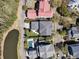 Enjoy this expansive aerial view of the home, boasting manicured landscaping, a pool, and proximity to a serene lake at 740 Stucco Ln, Mount Pleasant, SC 29464