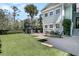 The backyard boasts artificial turf, an outdoor dining area, and a modern playset, ideal for entertaining at 740 Stucco Ln, Mount Pleasant, SC 29464