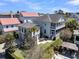 Aerial view of a backyard featuring a gazebo, patio set, green grass, and manicured trees, surrounded by privacy fence at 740 Stucco Ln, Mount Pleasant, SC 29464
