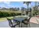 The backyard showcases an outdoor dining set, a modern playset, and lush artificial turf for relaxation and play at 740 Stucco Ln, Mount Pleasant, SC 29464