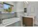 Bathroom featuring a soaking tub, single vanity, and a large window at 740 Stucco Ln, Mount Pleasant, SC 29464