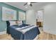 Comfortable bedroom with wood floors, a ceiling fan, and an ensuite bathroom entrance at 740 Stucco Ln, Mount Pleasant, SC 29464