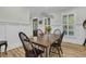 Bright dining room with natural wood table and modern lighting fixture at 740 Stucco Ln, Mount Pleasant, SC 29464