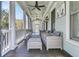 Inviting front porch with comfortable seating, ceiling fans, and serene views at 740 Stucco Ln, Mount Pleasant, SC 29464
