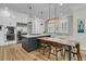Spacious kitchen features stainless steel appliances, custom cabinetry, and an island with barstool seating at 740 Stucco Ln, Mount Pleasant, SC 29464