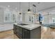 Open concept kitchen with island, modern appliances, and adjacent living area at 740 Stucco Ln, Mount Pleasant, SC 29464