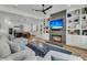 Cozy living room with fireplace, built-in shelving, and views into an adjacent kitchen at 740 Stucco Ln, Mount Pleasant, SC 29464