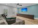 Relaxing living room featuring a large TV, comfortable seating, and a long cabinet at 740 Stucco Ln, Mount Pleasant, SC 29464