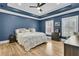 Bedroom with a tray ceiling, hardwood floors and shuttered windows at 740 Stucco Ln, Mount Pleasant, SC 29464