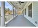 Spacious porch with columns, ceiling fans, and views of the surrounding landscape at 740 Stucco Ln, Mount Pleasant, SC 29464