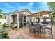 Charming back yard features patio, screened porch, furniture, potted plants and landscaping at 8095 Old London Rd, North Charleston, SC 29406