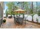 Relaxing backyard with a patio, table, umbrella and surrounding trees, creating a perfect outdoor retreat at 8095 Old London Rd, North Charleston, SC 29406