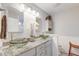 Elegant bathroom vanity featuring double vessel sinks, granite countertop, and a decorative mirror and lighting at 8095 Old London Rd, North Charleston, SC 29406