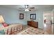 Bright bedroom features two twin beds, ceiling fan, wood floors and doorway to other rooms at 8095 Old London Rd, North Charleston, SC 29406