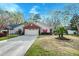 Charming single-story home with brick and vinyl siding, attached garage, and well-manicured lawn at 8095 Old London Rd, North Charleston, SC 29406