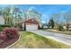 Charming home showcasing a two-car garage, red brick, and a well-manicured lawn on a sunny day at 8095 Old London Rd, North Charleston, SC 29406