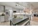 Modern eat-in kitchen with stainless steel appliances, granite countertops, and a stylish light fixture over a dining table at 8095 Old London Rd, North Charleston, SC 29406