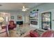 Inviting living room features a fireplace, large screen television, and hardwood flooring at 8095 Old London Rd, North Charleston, SC 29406