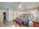 Spacious main bedroom featuring a walk-in closet, ensuite bathroom, wood floors, and elegant decor at 8095 Old London Rd, North Charleston, SC 29406