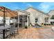 Beautiful outdoor patio with lounge chairs, dining table, and screened-in porch perfect for relaxing or entertaining at 8095 Old London Rd, North Charleston, SC 29406