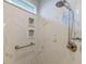 Luxurious shower with marble tile, a built-in niche for storage, and a modern shower head and handrail at 8095 Old London Rd, North Charleston, SC 29406