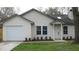 Charming single-story home with a well-maintained lawn, a one car garage, and vinyl siding at 8311 Whitehaven Dr, North Charleston, SC 29420