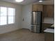 Well-lit kitchen with stainless steel refrigerator, light wood cabinets, and light countertops at 8311 Whitehaven Dr, North Charleston, SC 29420