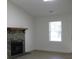 Cozy living room with a stone fireplace, bright white walls, and a large window at 8311 Whitehaven Dr, North Charleston, SC 29420