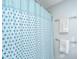 Close up of a shower featuring a blue and white shower curtain and towel rack at 1002 Elm Hall Cir, Summerville, SC 29483